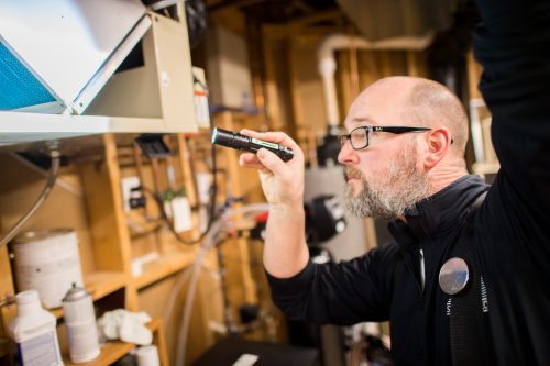 HVAC inspection with a flashlight