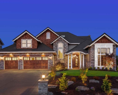 large lighted home at dusk